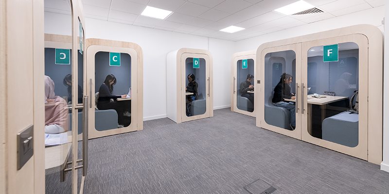 Study pods in library with students sat inside