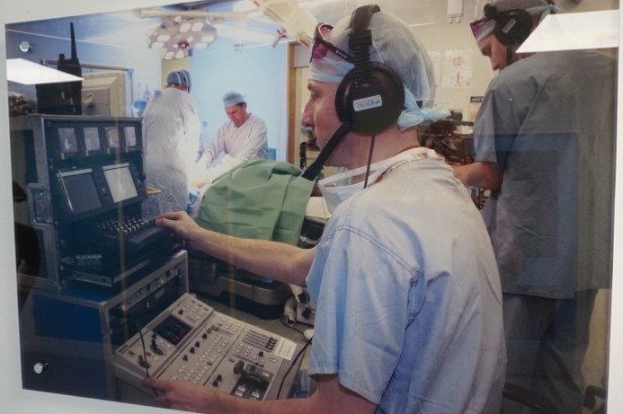 A technician watches a monitor in the operating room.
