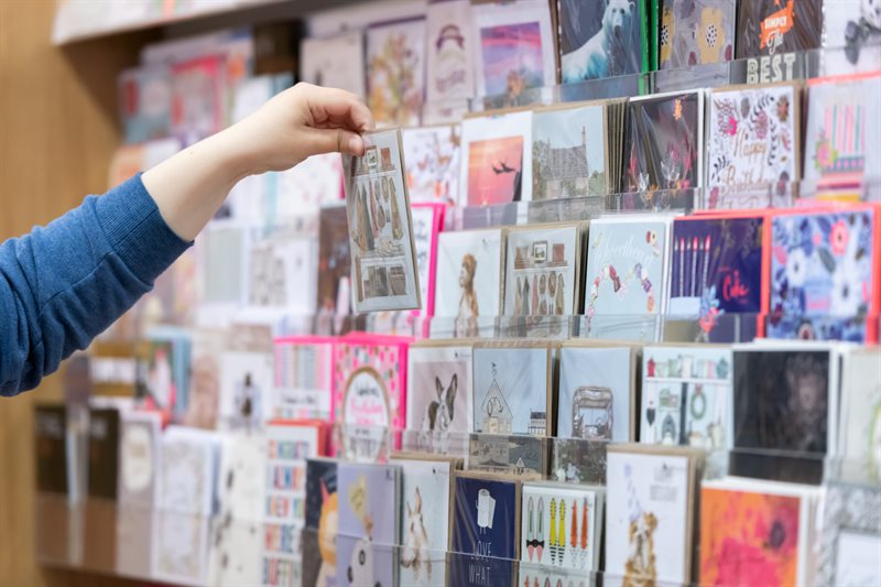 A customer selecting a greeting card.