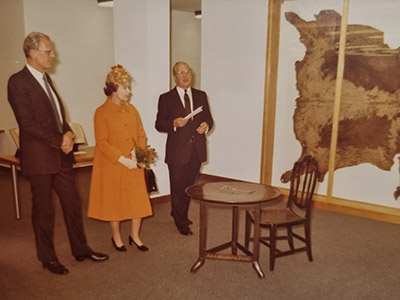 Robert Lowe, Queen Elizabeth II and Harry Axton at opening ceremony of St George's looking at Blossom the cow's hide
