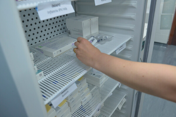Vaccine being placed in fridge