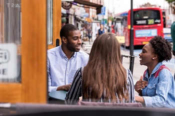 Students eating at a restaurant in Tooting.