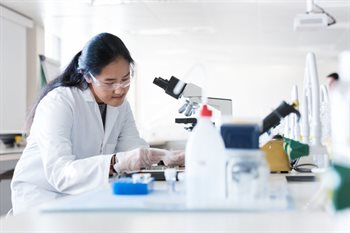 A student using a microscope.